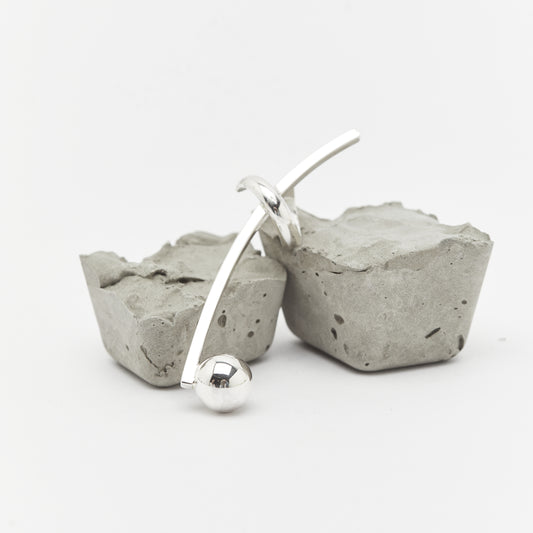 the SENSE IT earcuff over rocks. A contrast and balance of silver jewellery by AROE