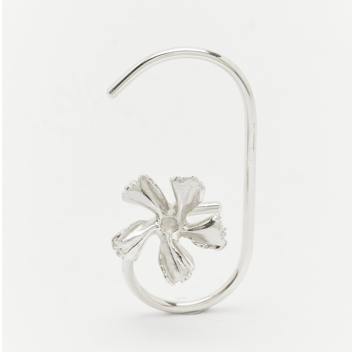Silver earring with a flower design on a white background Unique handcrafted silver ear cuff – statement jewellery by AROE.