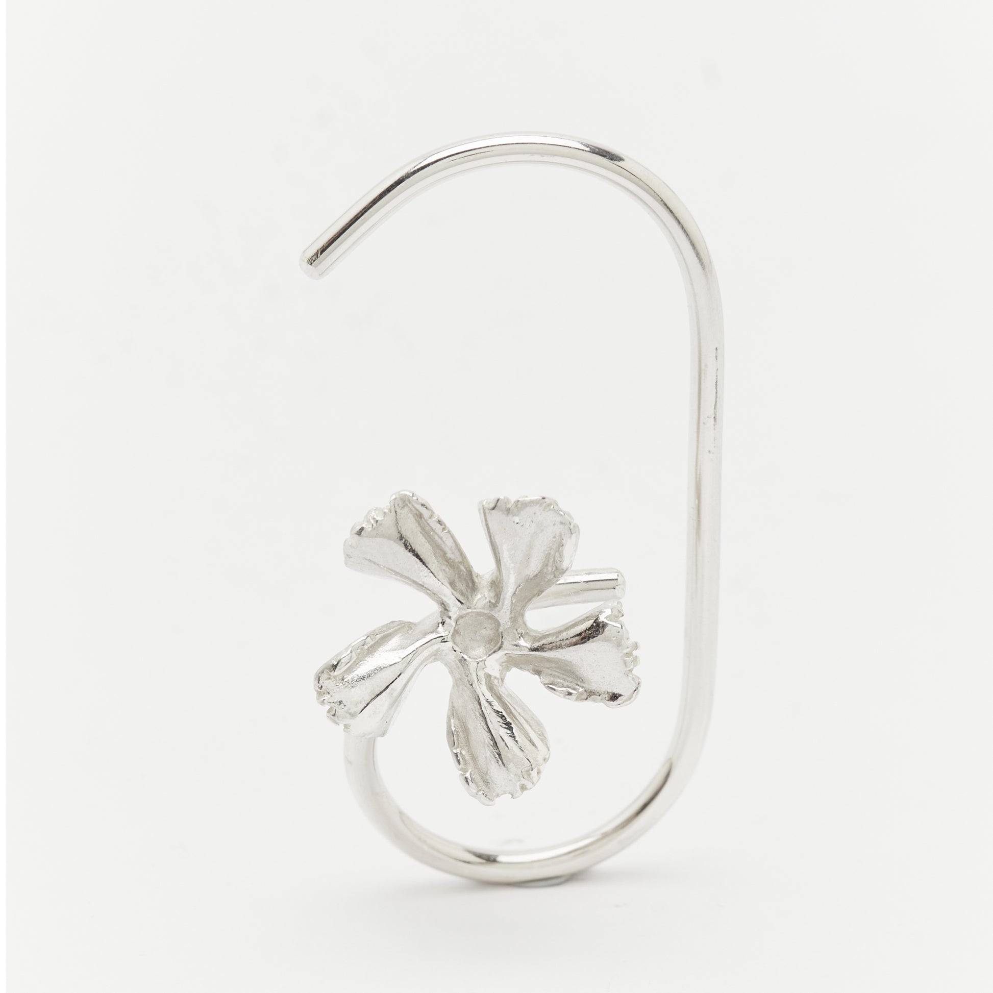 Silver earring with a flower design on a white background Unique handcrafted silver ear cuff – statement jewellery by AROE.