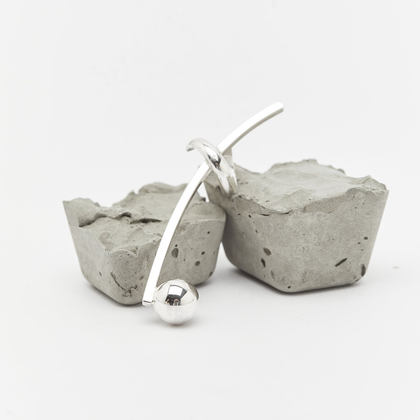 the SENSE IT earcuff over rocks. A contrast and balance of silver jewellery by AROE