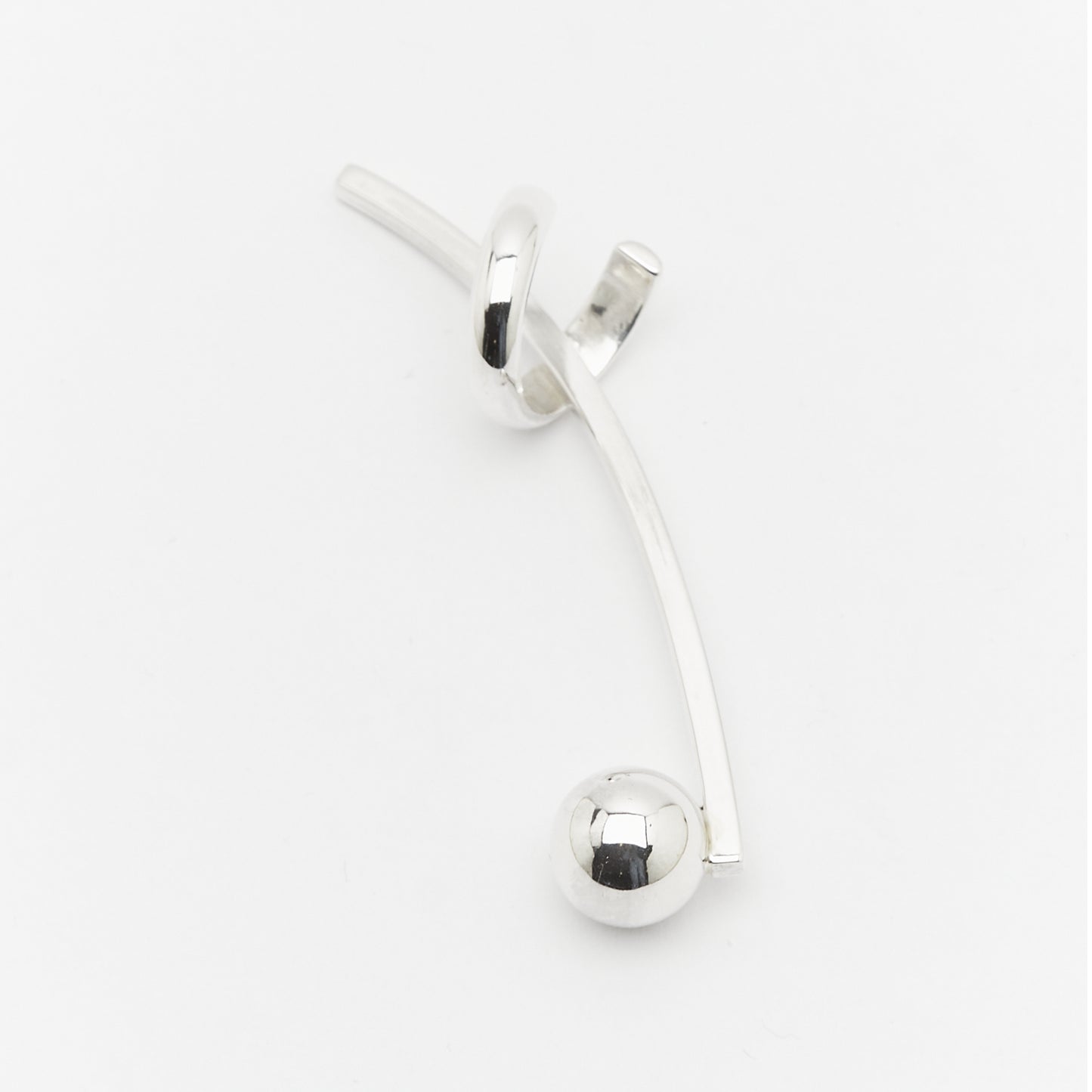 a side full view of the SENSE IT silver earcuff, a musical curve with beautiful balance.