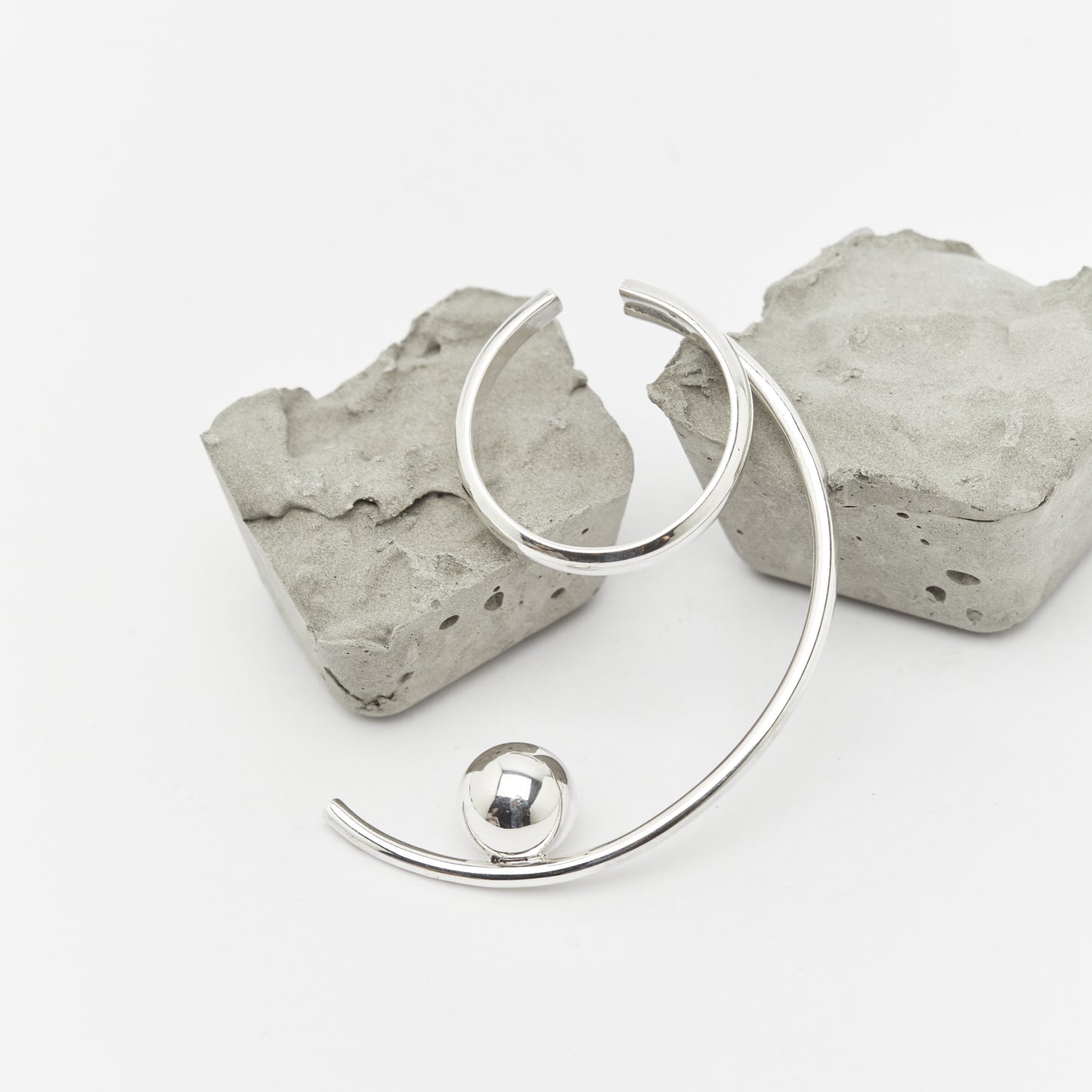 the silver TUNE IT earcuff over rocks, Unique handcrafted silver ear cuff – statement jewellery by AROE.